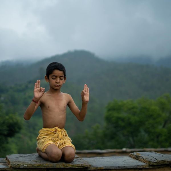 Person meditating in a lotus position with a serene expression.