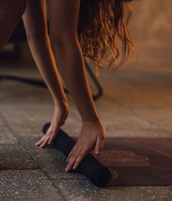 Woman performing a gentle yoga stretch in a calm environment.